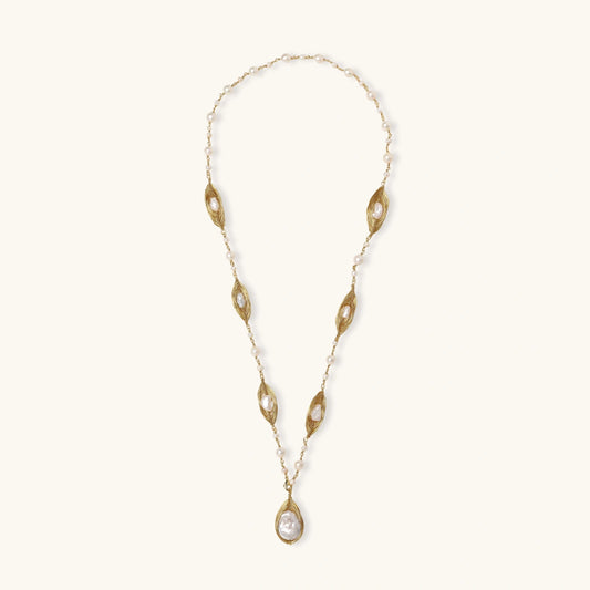 14K gold plated necklace with organic leaf motifs and freshwater pearls arranged in an elegant chain design on neutral background.