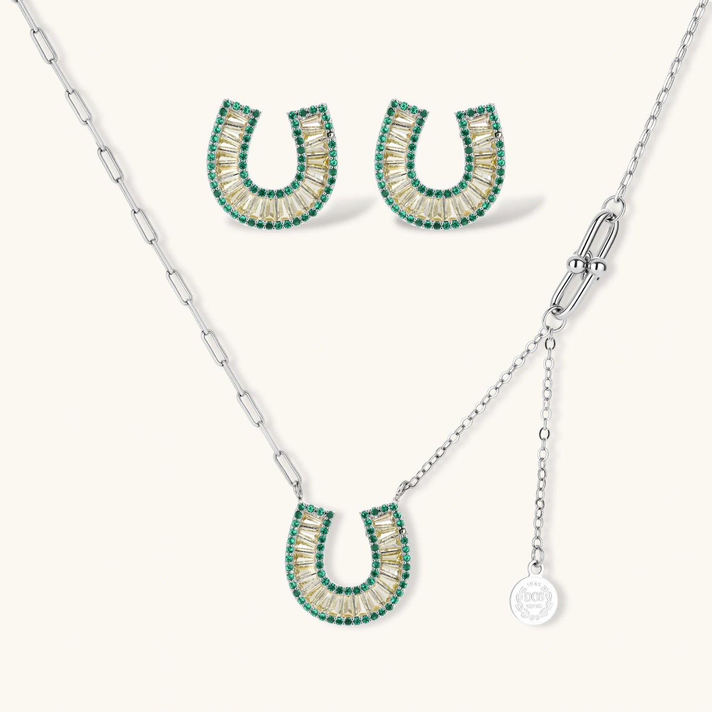 Geometric horseshoe-shaped jewelry set with radiating white zirconia center and jade-green border stones on white background.