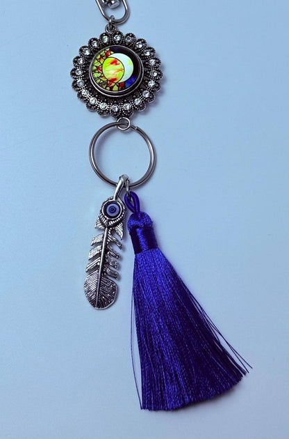 Sonne & Böser Blick Feder-Taschenanhänger: Boho-Handtaschen-Schlüsselanhänger mit violetter Quaste