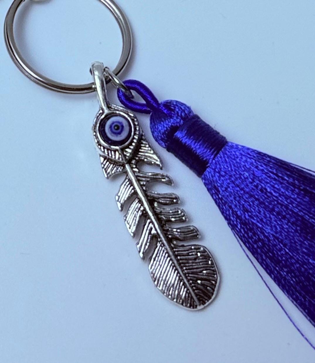 Sonne & Böser Blick Feder-Taschenanhänger: Boho-Handtaschen-Schlüsselanhänger mit violetter Quaste